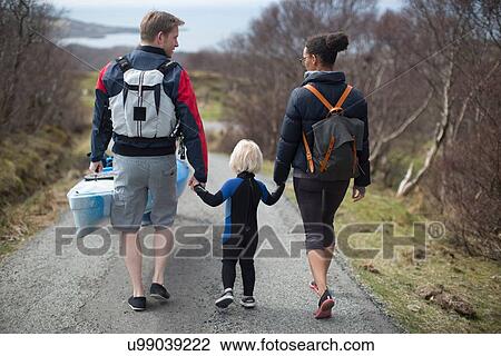 Family walking on country road holding hands, rear view View Large Photo Image Stock Image - Family walking on country road holding hands, rear view. Fotosearch