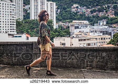 Fashion model walking and smiling at camera View Large Photo Image Stock Image - Fashion model walking and smiling at camera. Fotosearch