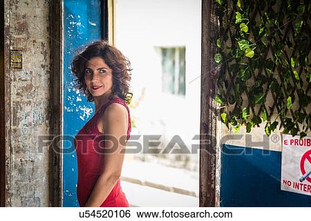 Stock Photograph - Fashion model wearing red dress and smiling. Fotosearch