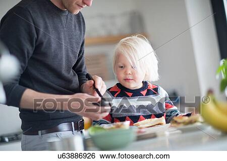 Father andf son preparing food in kitchen View Large Photo Image Stock Photograph - Father andf son preparing food in kitchen. Fotosearch