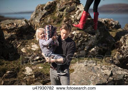 Father carrying son in arms View Large Photo Image Stock Image - Father carrying son in arms. Fotosearch