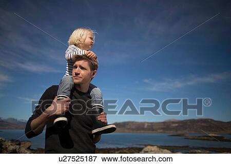 Stock Photo - Father carrying son on shoulders, Loch Eishort, Isle of Skye, Hebrides, Scotland. Fotosearch