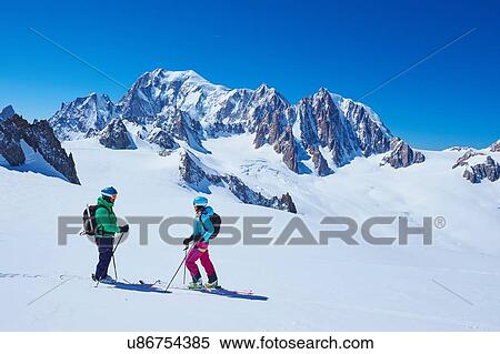 Female and male skiers talking on Mont Blanc massif, Graian Alps, France View Large Photo Image Stock Photography - Female and male skiers talking on Mont Blanc massif, Graian Alps, France. Fotosearch