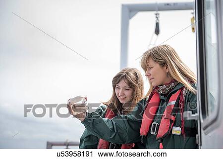 Female scientists inspecting sample of plankton on research ship View Large Photo Image Stock Image - Female scientists inspecting sample of plankton on research ship. Fotosearch