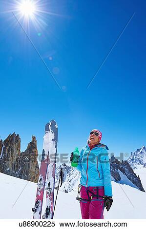 Female skier drinking water on Mont Blanc massif, Graian Alps, France View Large Photo Image Stock Photography - Female skier drinking water on Mont Blanc massif, Graian Alps, France. Fotosearch