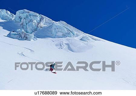 Female skier moving down Mont Blanc massif, Graian Alps, France View Large Photo Image Stock Photo - Female skier moving down Mont Blanc massif, Graian Alps, France. Fotosearch