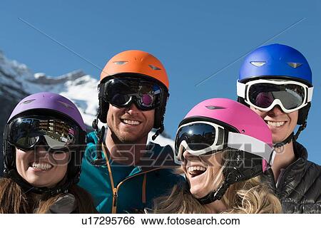 Four friends wearing ski helmets and goggles, laughing View Large Photo Image Stock Photograph - Four friends wearing ski helmets and goggles, laughing. Fotosearch