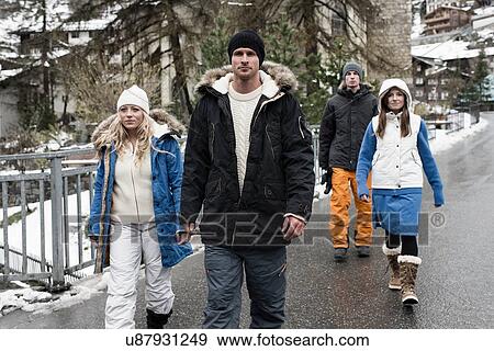 Four friends wearing winter clothes walking View Large Photo Image Stock Photo - Four friends wearing winter clothes walking. Fotosearch