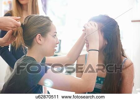 Four teenage girls doing each others hair and make up in bedroom View Large Photo Image Stock Image - Four teenage girls doing each others hair and make up in bedroom. Fotosearch