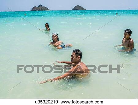 Four young adult friends playing in sea at Lanikai Beach, Oahu, Hawaii, USA View Large Photo Image Stock Photo - Four young adult friends playing in sea at Lanikai Beach, Oahu, Hawaii, USA. Fotosearch