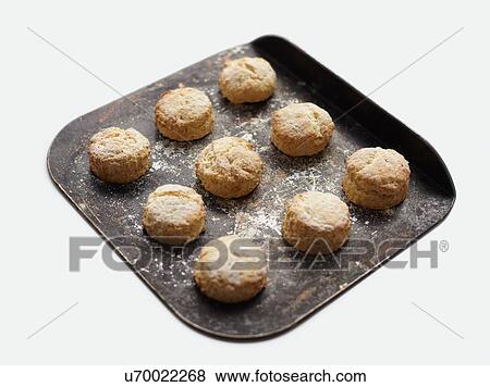Stock Photo - Freshly baked scones on baking tray. Fotosearch
