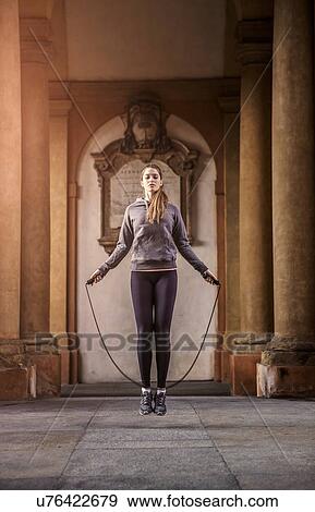 Front view of woman wearing sports clothes using skipping rope View Large Photo Image Stock Photo - Front view of woman wearing sports clothes using skipping rope. Fotosearch