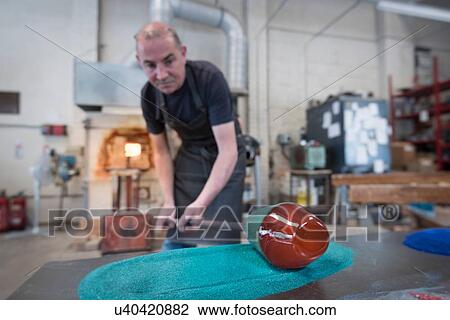Glassblower adding colour to hot glass View Large Photo Image Stock Image - Glassblower adding colour to hot glass. Fotosearch