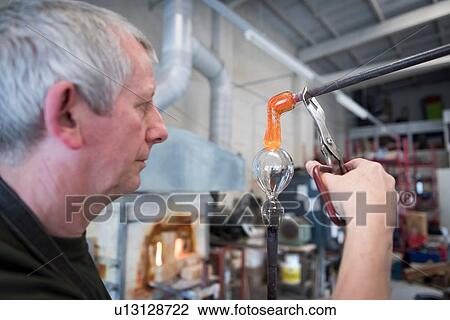 Glassblower adding molten glass stem to glass View Large Photo Image Stock Image - Glassblower adding molten glass stem to glass. Fotosearch