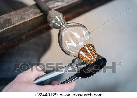 Stock Photo - Glassblower adding molten glass stem to glass. Fotosearch
