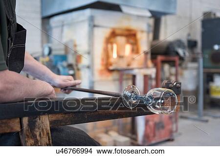Picture - Glassblower forming hot glass, close up. Fotosearch