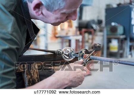 Glassblower forming hot glass object View Large Photo Image Stock Image - Glassblower forming hot glass object. Fotosearch