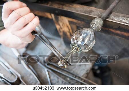 Glassblower forming hot glass object, close up View Large Photo Image Stock Image - Glassblower forming hot glass object, close up. Fotosearch