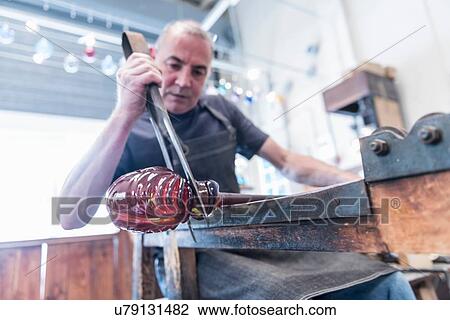 Glassblower forming hot glass View Large Photo Image Stock Image - Glassblower forming hot glass. Fotosearch