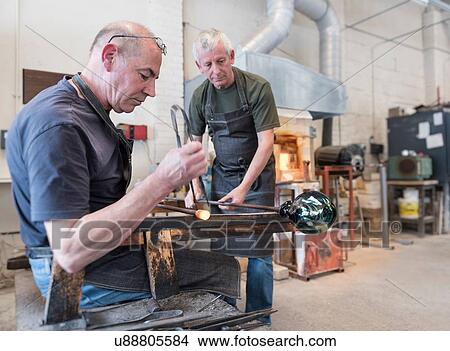 Glassblower forming molten glass View Large Photo Image Picture - Glassblower forming molten glass. Fotosearch