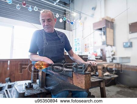 Glassblower forming molten glass View Large Photo Image Picture - Glassblower forming molten glass. Fotosearch