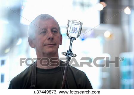 Stock Image - Glassblower with complete drinking glass. Fotosearch