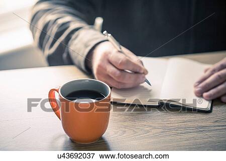 Hands of mature man writing in notebook View Large Photo Image Stock Photo - Hands of mature man writing in notebook. Fotosearch