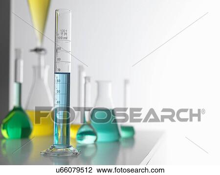 Stock Image - Laboratory glassware on lab bench with a graduated measuring cylinder in foreground. Fotosearch