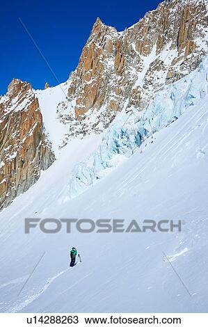 Stock Image - Lone male skier on Mont Blanc massif, Graian Alps, France. Fotosearch