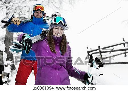 Man and woman carrying skis View Large Photo Image Picture - Man and woman carrying skis. Fotosearch