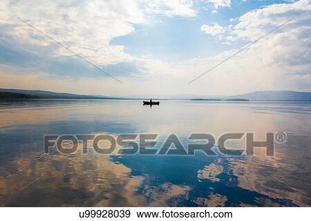 Man in boat on lake, Sarsy village, Sverdlovsk region, Russia View Large Photo Image Stock Photo - Man in boat on lake, Sarsy village, Sverdlovsk region, Russia. Fotosearch