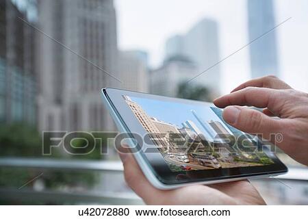 Man using digital tablet, focus on hands, Hong Kong, China View Large Photo Image Stock Image - Man using digital tablet, focus on hands, Hong Kong, China. Fotosearch