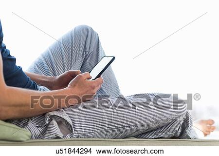 Picture - Man using smartphone, cropped. Fotosearch