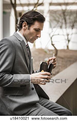 Mature businessman, eating lunch from takeaway box, outdoors View Large Photo Image Stock Image - Mature businessman, eating lunch from takeaway box, outdoors. Fotosearch