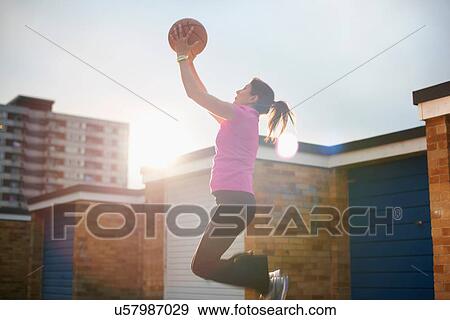 Mature female basketball player catching ball mid air View Large Photo Image Stock Photo - Mature female basketball player catching ball mid air. Fotosearch