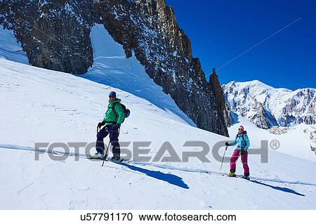 Mature male and female skiers moving up Mont Blanc massif, Graian Alps, France View Large Photo Image Stock Image - Mature male and female skiers moving up Mont Blanc massif, Graian Alps, France. Fotosearch