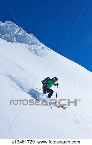 Mature male skier speeding down Mont Blanc massif, Graian Alps, France View Large Photo Image Stock Photo - Mature male skier speeding down Mont Blanc massif, Graian Alps, France. Fotosearch