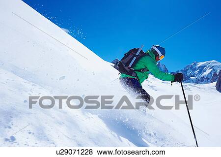 Mature male skier speeding downhill on Mont Blanc massif, Graian Alps, France View Large Photo Image Stock Photo - Mature male skier speeding downhill on Mont Blanc massif, Graian Alps, France. Fotosearch