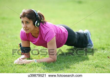 Mature woman doing plank exercises in park View Large Photo Image Stock Image - Mature woman doing plank exercises in park. Fotosearch