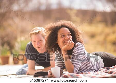 Mid adult couple relaxing outdoors View Large Photo Image Picture - Mid adult couple relaxing outdoors. Fotosearch