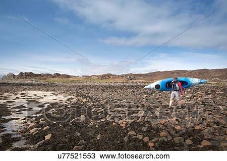 Mid adult man carrying canoe, Loch Eishort, Isle of Skye, Hebrides, Scotland View Large Photo Image Stock Image - Mid adult man carrying canoe, Loch Eishort, Isle of Skye, Hebrides, Scotland. Fotosearch