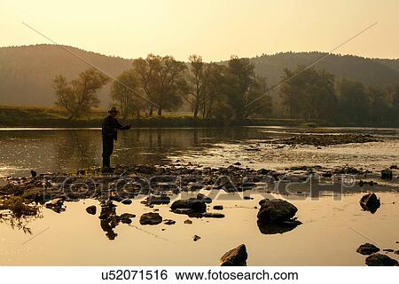 Mid adult man fishing in lake, Sarsy village, Sverdlovsk region, Russia View Large Photo Image Stock Photograph - Mid adult man fishing in lake, Sarsy village, Sverdlovsk region, Russia. Fotosearch