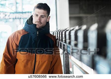 Mid adult man wearing coat, looking away View Large Photo Image Stock Photograph - Mid adult man wearing coat, looking away. Fotosearch