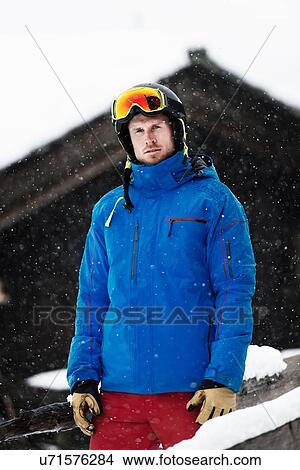 Mid adult man wearing ski jacket and helmet, portrait View Large Photo Image Picture - Mid adult man wearing ski jacket and helmet, portrait. Fotosearch