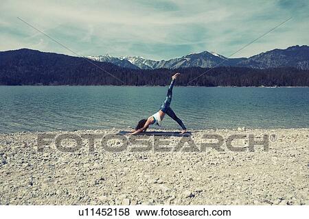 Mid adult woman, beside lake, in yoga position View Large Photo Image Stock Photo - Mid adult woman, beside lake, in yoga position. Fotosearch