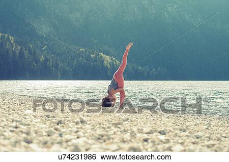 Mid adult woman, beside lake, in yoga position View Large Photo Image Stock Photograph - Mid adult woman, beside lake, in yoga position. Fotosearch
