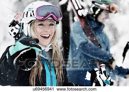 Mid adult woman holding skis, laughing View Large Photo Image Stock Image - Mid adult woman holding skis, laughing. Fotosearch