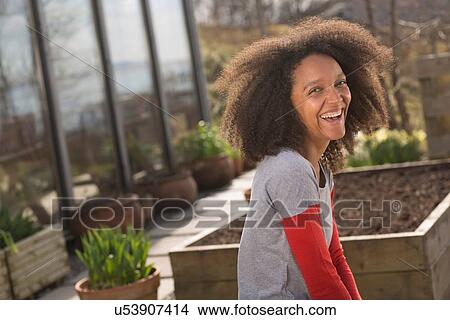 Picture - Mid adult woman laughing, portrait. Fotosearch