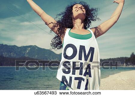 Mid adult woman, outdoors, in yoga position View Large Photo Image Stock Image - Mid adult woman, outdoors, in yoga position. Fotosearch