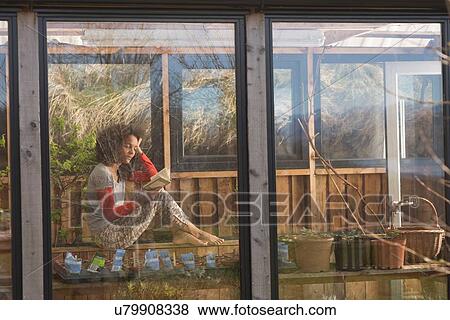 Mid adult woman reading book View Large Photo Image Stock Photo - Mid adult woman reading book. Fotosearch
